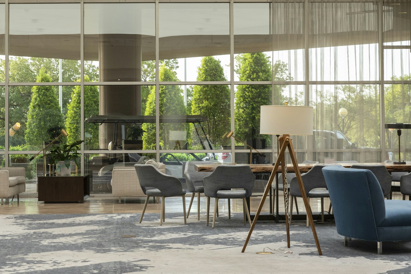 Hotel lounge with chairs, tables and large windows